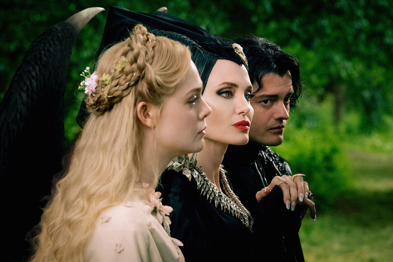 Elle Fanning (left), Angelina Jolie and Sam Riley co-star in “Maleficent: Mistress of Evil.” (Jaap Buitendijk/Walt Disney Motion Pictures)