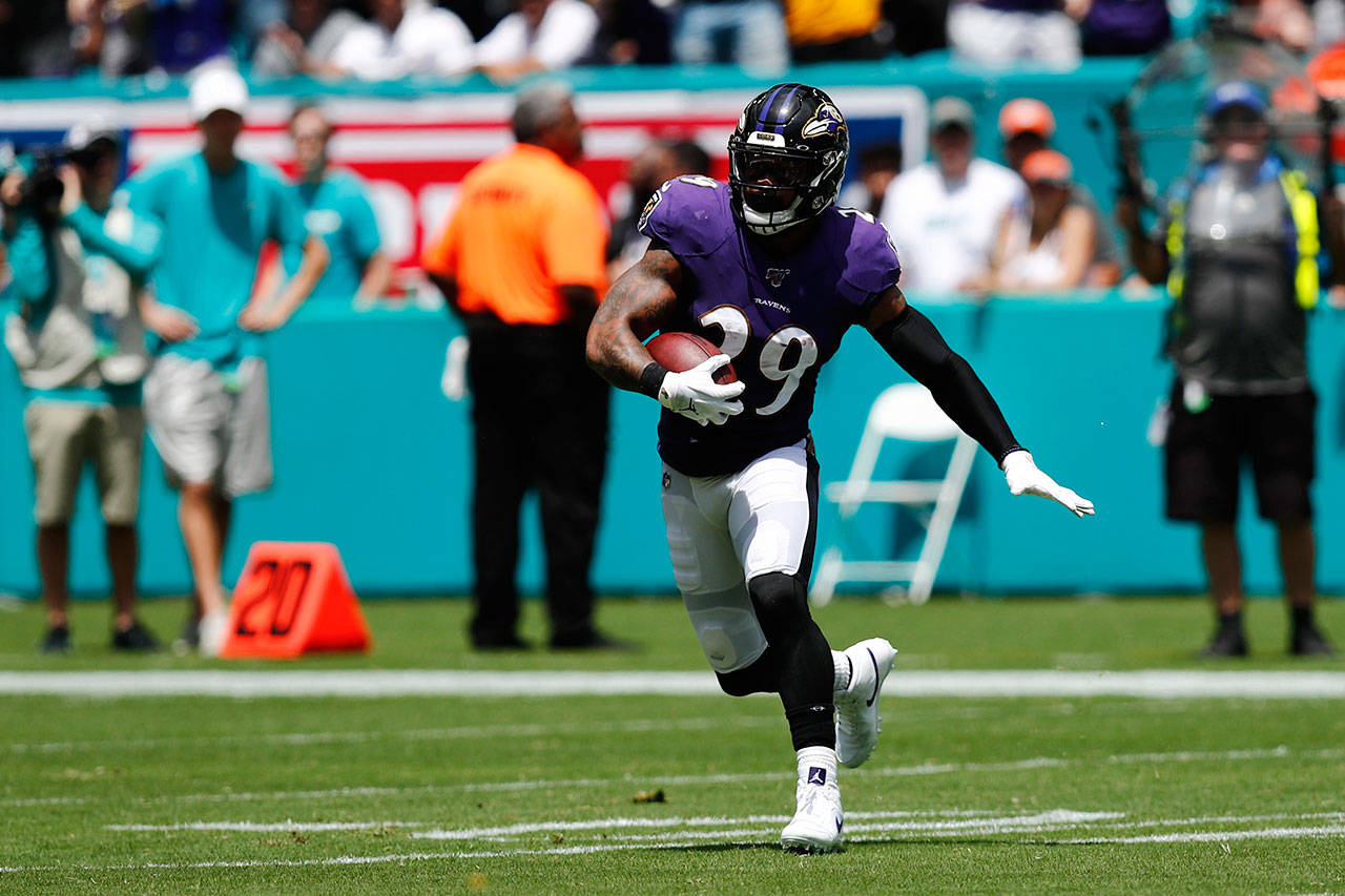 Ravens safety Earl Thomas (29) runs after intercepting a pass by Dolphins quarterback Ryan Fitzpatrick during the first half of a game Sept. 8, 2019, in Miami Gardens, Fla. (AP Photo/Brynn Anderson)