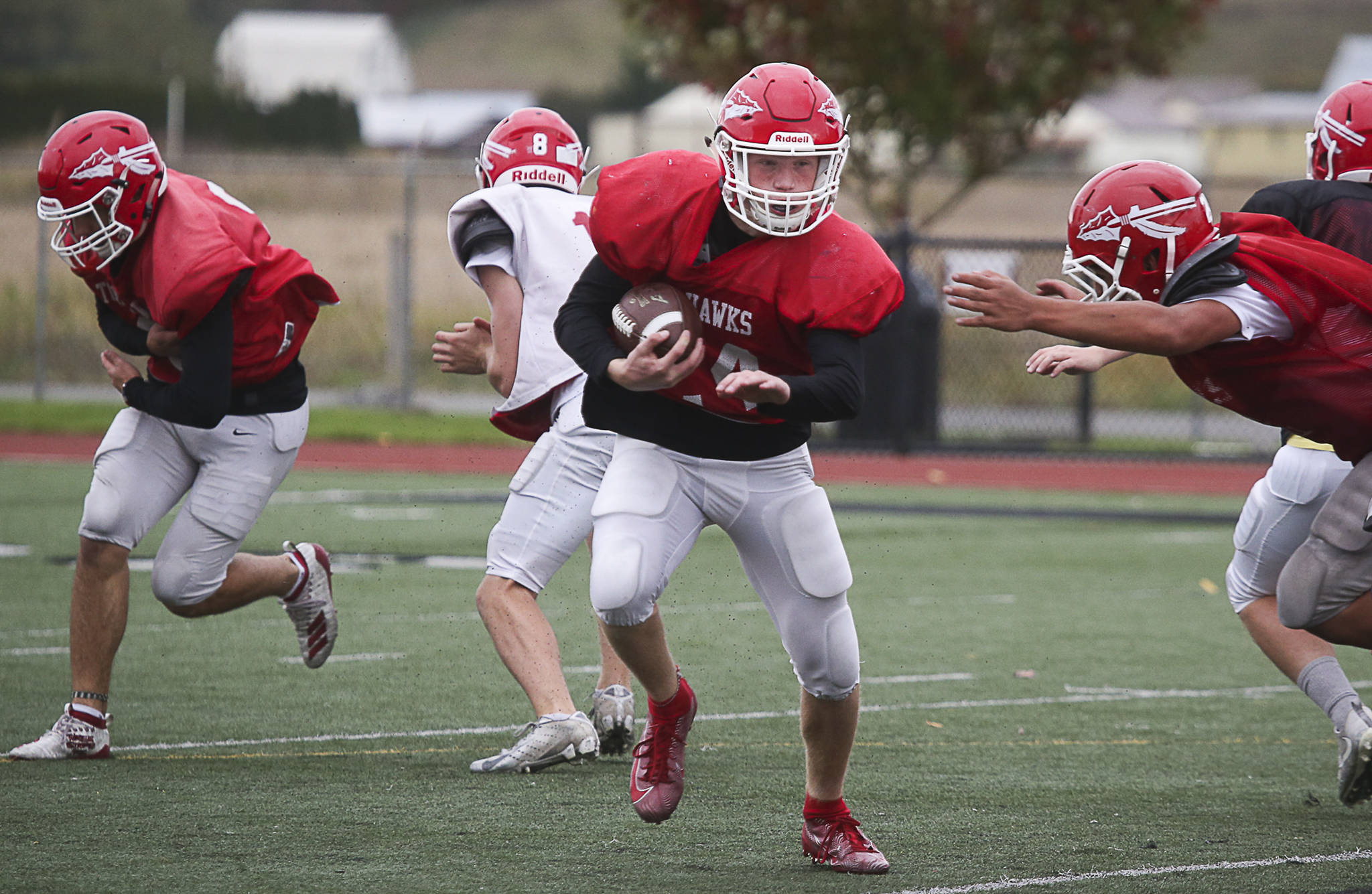 Marysville Pilchuck running back Dylan Carson (center) carries the ball during practice Thursday afternoon. Carson is part of a high-powered Slot-T rushing attack that’s averaging 8.2 yards per carry and 330 yards per game. (Andy Bronson / The Herald)