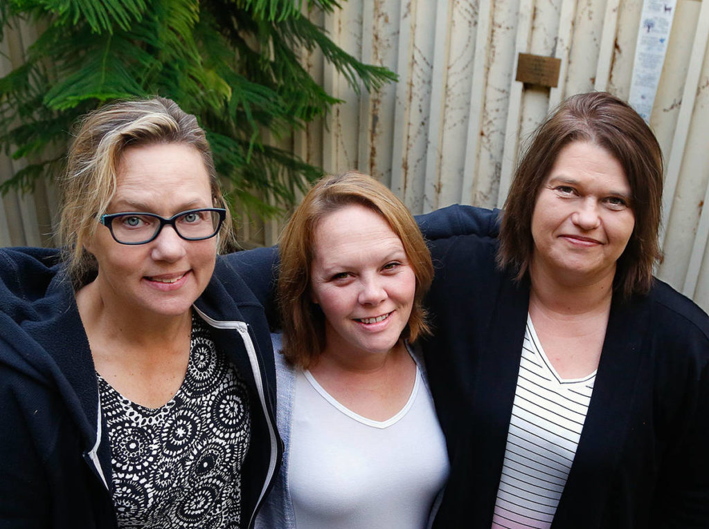Everett Recovery Cafe founder and executive director Wendy Grove (left) and the cafe’s operations director Sarah Brooks with Danita Lott (right) who will share her personal experience with addiction at a Nov. 9 fundraiser for the nonprofit. (Dan Bates / The Herald)
