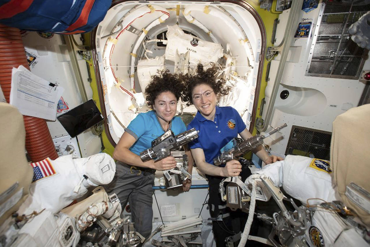 U.S. astronauts Jessica Meir (left) and Christina Koch pose for a photo in the International Space Station. On Friday, the two performed a spacewalk to replace a broken battery charger. (NASA via AP)