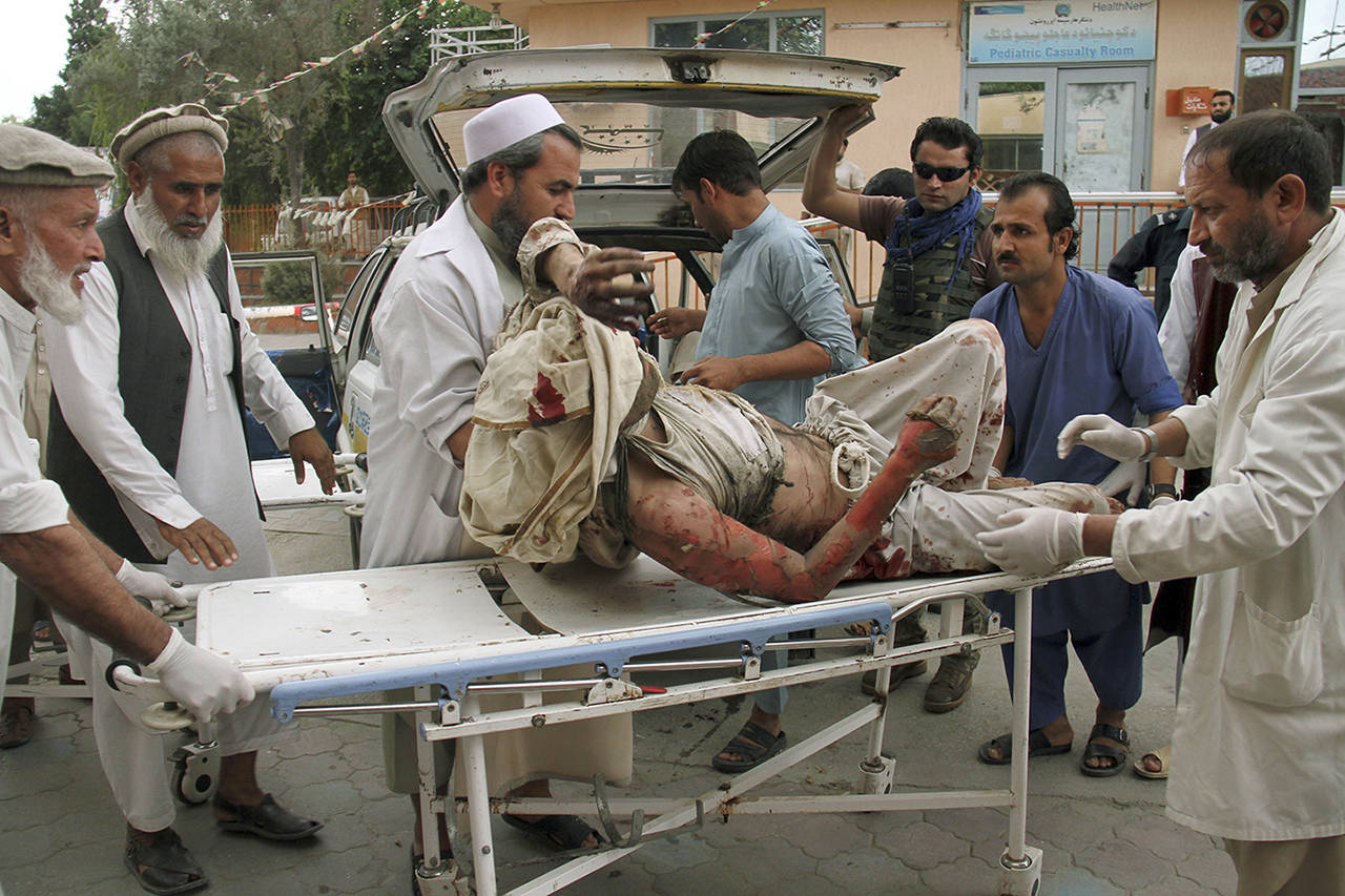 A wounded man is brought by stretcher into a hospital after a mortar was fired by insurgents in Haskamena district of Jalalabad east of Kabul, Afghanistan, on Friday. An Afghan official says at least several people have been killed during Friday prayers when a mortar fired by insurgents blasted through the roof of a mosque. (AP Photo/Wali Sabawoon)