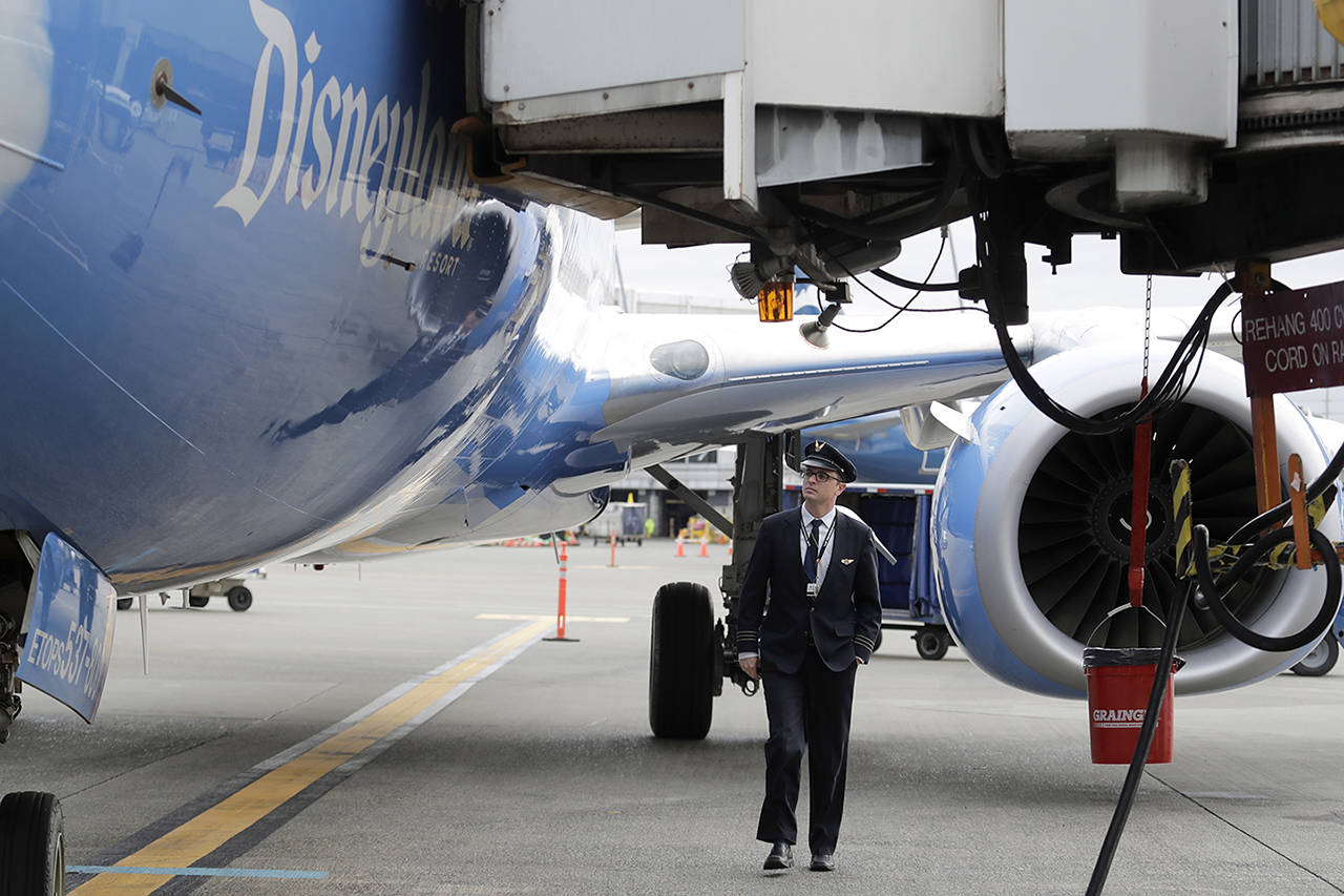 First officer Robb Crawford, a pilot for Alaska Airlines, does a pre-flight inspection of a Boeing 737-800 on Oct. 7 at Seattle-Tacoma International Airport. (AP Photo/Ted S. Warren)