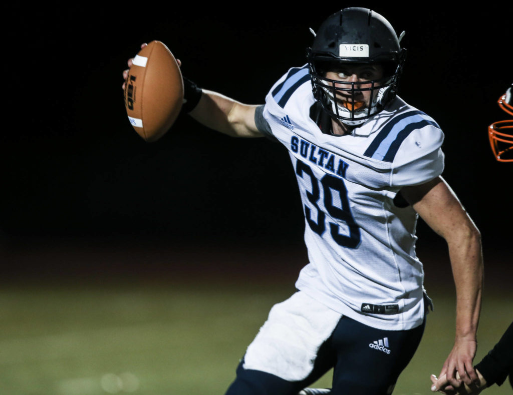 Sultan’s Willy Bennett runs to escape a tackle during a game against Granite Falls on Friday in Granite Falls. (Olivia Vanni / The Herald)
