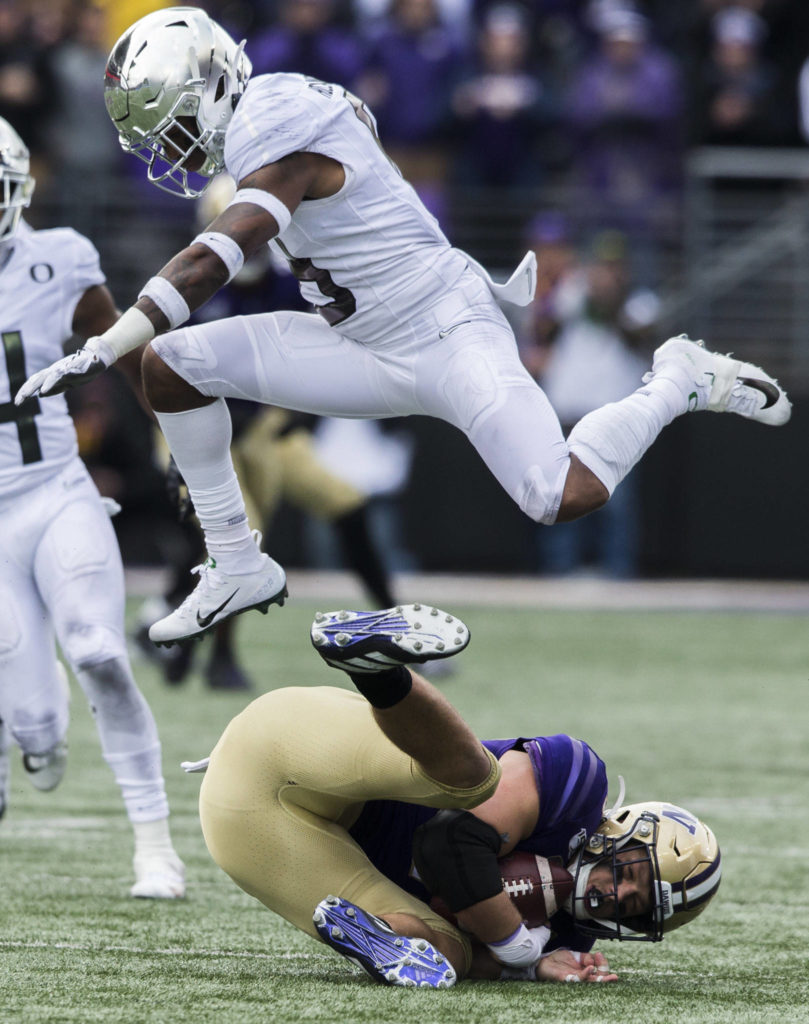 Oregon Ducks Jevon Holland jumps over Washington’s Cade Otton after making a catch during the game against Oregon on Saturday, Oct. 19, 2019 in Seattle, Wash. (Olivia Vanni / The Herald)
