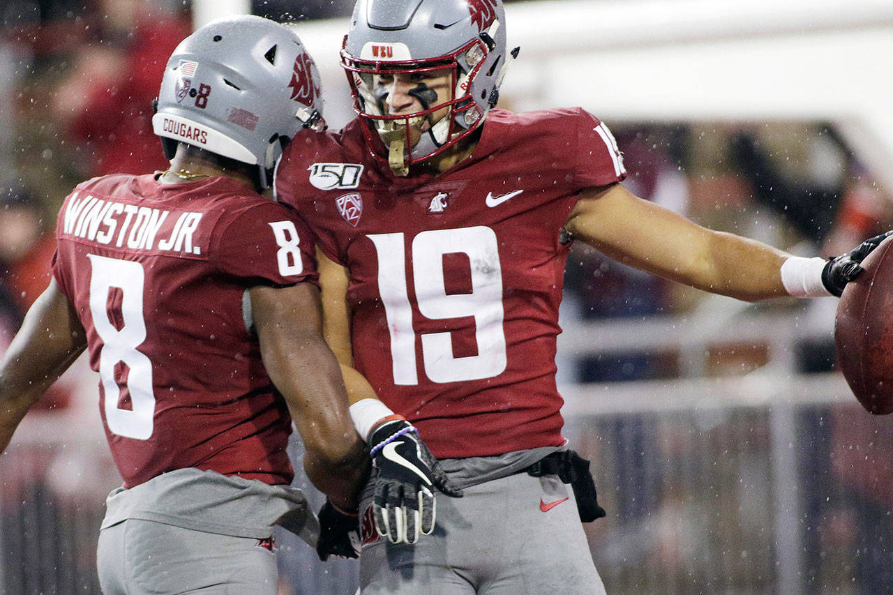 Washington State wide receiver Brandon Arconado (19) celebrates his touchdown with teammate Easop Winston Jr. (8) during the second half of a game against Colorado on Oct. 19, 2019, in Pullman. (AP Photo/Young Kwak)