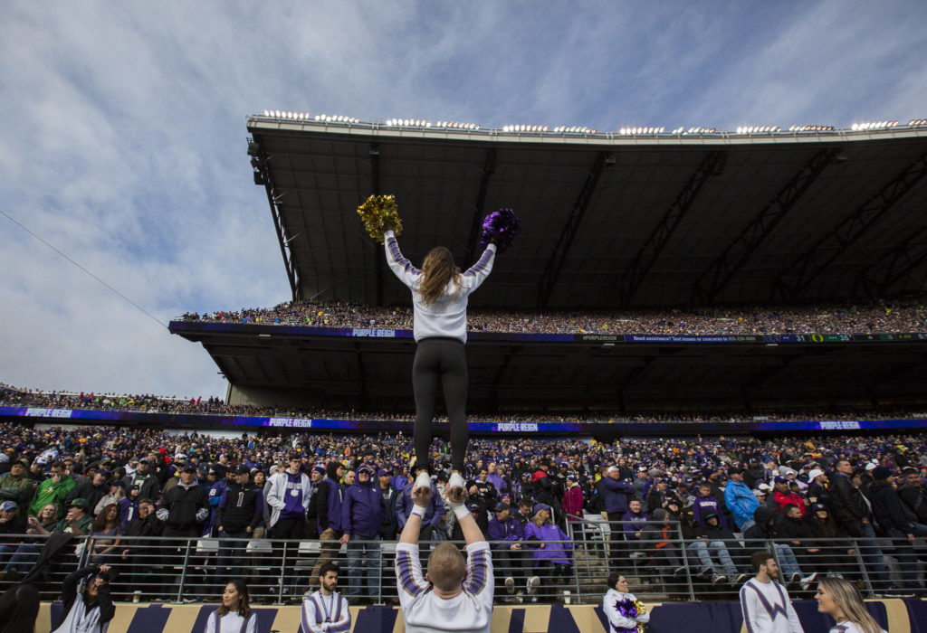 A cheerleader is lifted into the air in front of a sold out stadium during the game against Oregon on Saturday, Oct. 19, 2019 in Seattle, Wash. (Olivia Vanni / The Herald)