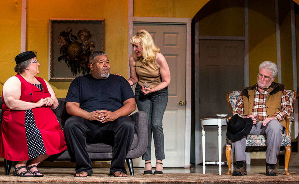 Cast members, from left, Iris Lilly and Ric Calhoun are on stage with Laura Shriner during show “Exit the Body,” performed this year at the Historic Everett Theatre. Laura’s husband Curt Shriner sits at right. (Olivia Vanni, The Herald)
