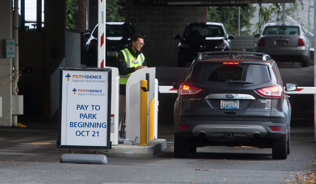 Paid parking is set to start Monday at both of Providence Regional Medical Center Everett campuses for patients and visitors. Rates start at $1 for 90 minutes and rise to $4 for six or more hours. (Andy Bronson / The Herald)
