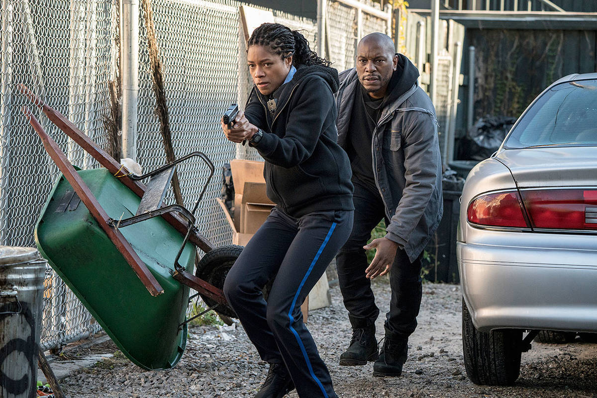 Naomie Harris plays a police officer pursued by rogue killer cops, and Tyrese Gibson is a man who warily comes to her aid, in “Black and Blue.” (Sony Pictures)