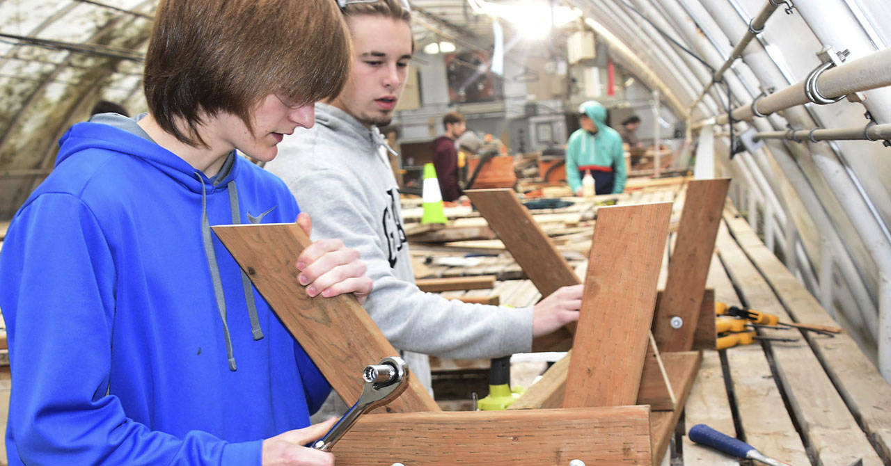 Arlington students Shawn McKinley and Brock Schamp build a bench during their Regional Apprenticeship Pathways class. (The Arlington Times)