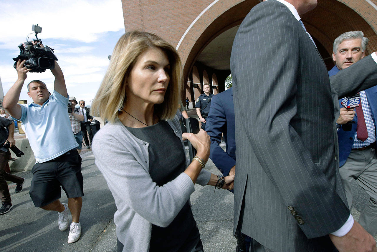 Actress Lori Loughlin departs federal court in Boston on Aug. 27 after a hearing in a nationwide college admissions bribery scandal. Loughlin, her fashion designer husband, Mossimo Giannulli, and nine other parents face new charges in the college admissions scandal. Federal prosecutors announced Tuesday that the parents were indicted on charges of conspiracy to commit federal program bribery. (AP Photo/Steven Senne, File)
