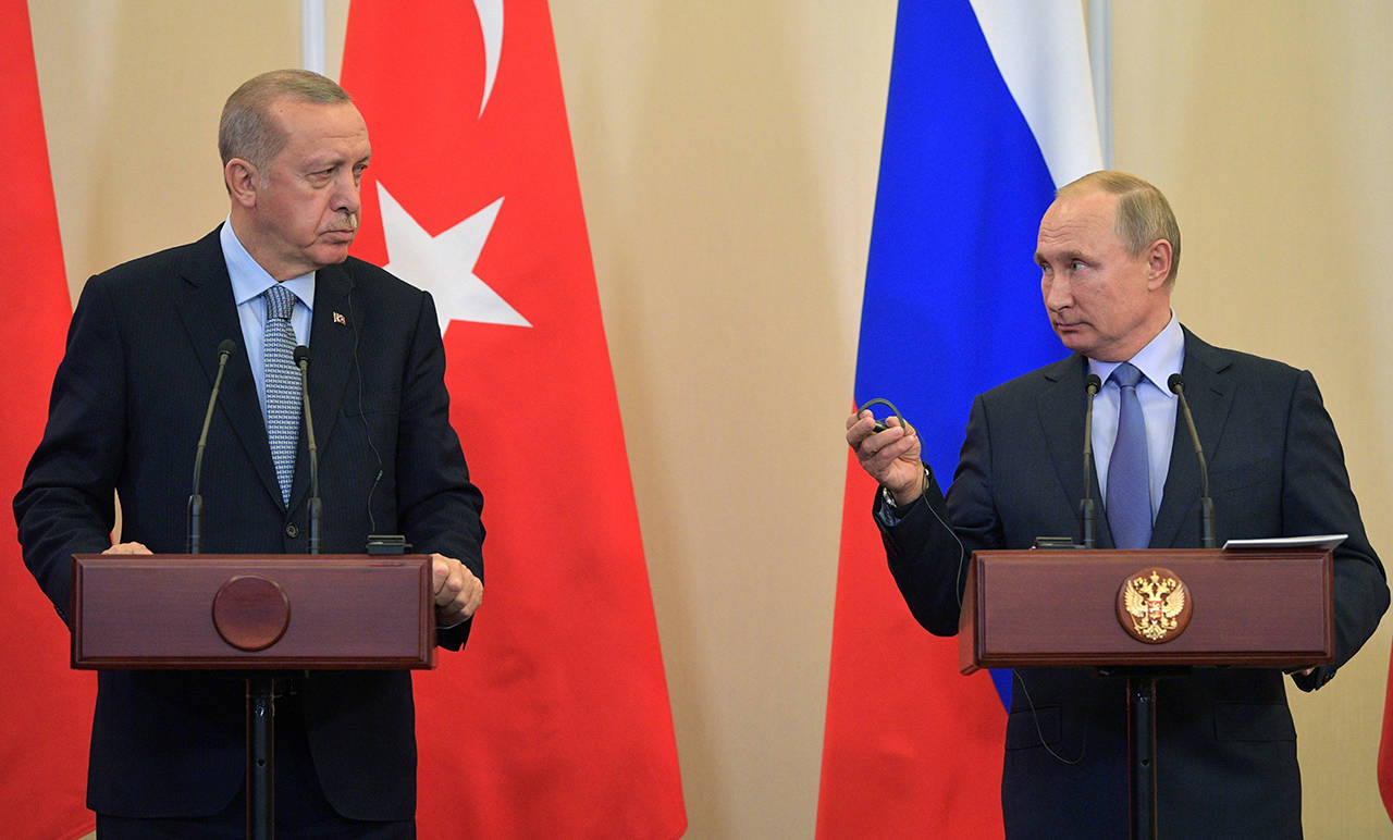 Russian President Vladimir Putin (right) and Turkish President Recep Tayyip Erdogan look at each other during a joint news conference after their talks in the Bocharov Ruchei residence in the Black Sea resort of Sochi, Russia, on Tuesday. (Alexei Druzhinin/Sputnik Kremlin Pool Photo via AP)