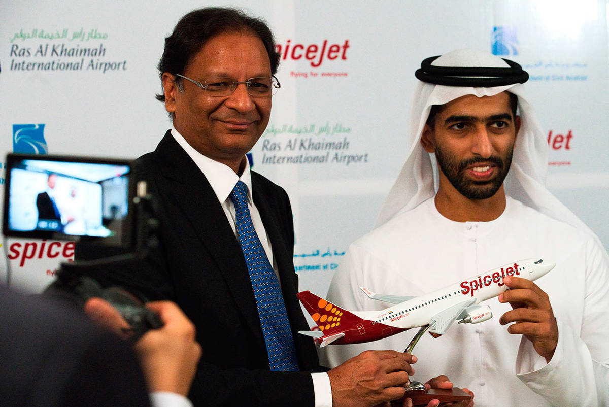 SpiceJet chairman and managing director Ajay Singh (left) and Sheikh Khalid bin Saud Al Qasimi, a son of Ras al-Khaimah ruler Sheikh Saud bin Saqr Al Qasimi pose for photographs during a news conference Wednesday in Ras al-Khaimah, United Arab Emirates. India’s low-cost airline SpiceJet announced plans Wednesday to build its first international hub in the United Arab Emirates, offering a pledge of support to Boeing Co. by saying it would use now-grounded 737 MAX aircraft in the operation once regulators approve the planes for flight. (AP Photo/Jon Gambrell)