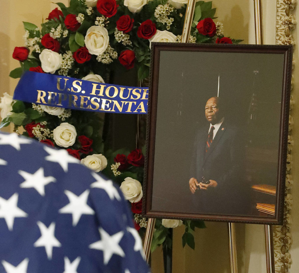 A photo of Rep. Elijah Cummings stands next to his flag-draped casket as he lies in state at the U.S. Capitol in Washington on Thursday. (AP Photo/Wilfredo Lee, Pool)
