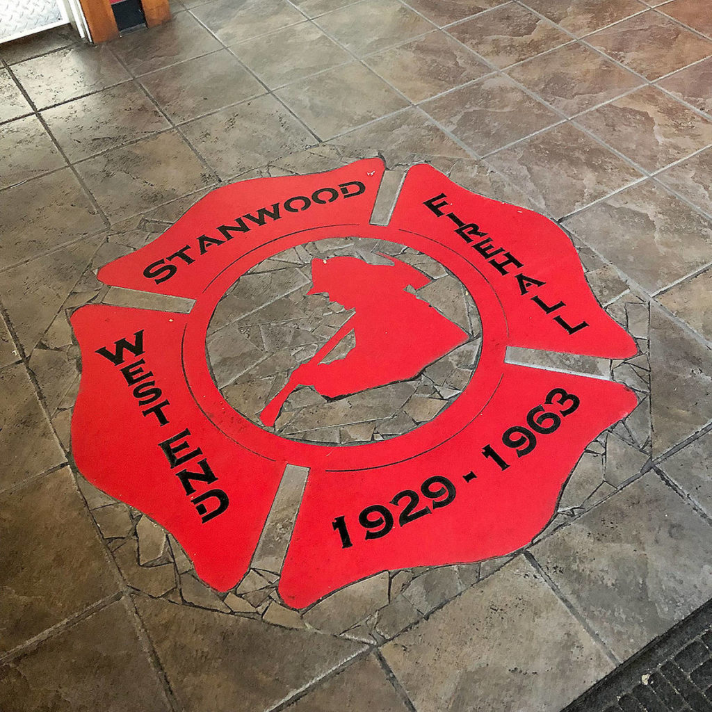 An emblem memorializing the old Stanwood Fire Hall sits on the floor of SAAL Brewing Co.’s new taproom and restaurant. (Aaron Swaney)
