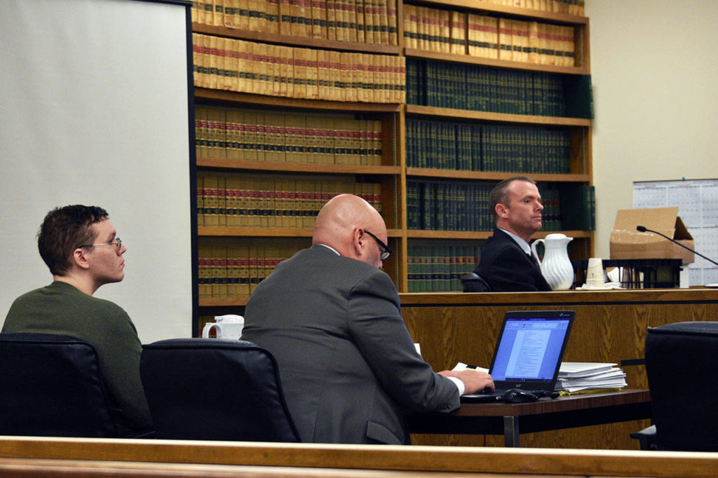 Defendant Anthony Garver (left) sits beside his attorney, Jon Scott, as they listen to questioning of sheriff’s detective Brad Walvatne on Thursday, during Garver’s murder trial in Snohomish County Superior Court. (Caleb Hutton / The Herald)
