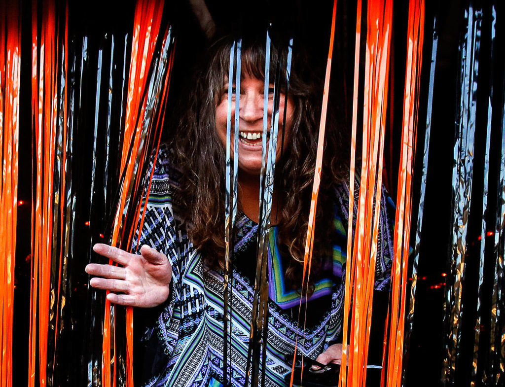 Ivy Fulmer emerges from a spooky tunnel she built for the children who visit her Halloween exhibit in the Riverside Neighborhood in Everett. (Dan Bates / The Herald)
