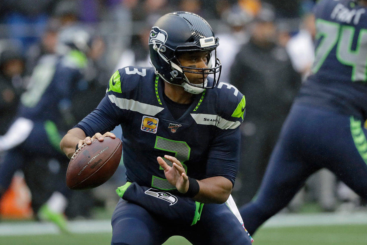 Seahawks quarterback Russell Wilson drops back to pass during the first half of a game against the Ravens on Oct. 20, 2019, in Seattle. (AP Photo/Elaine Thompson)