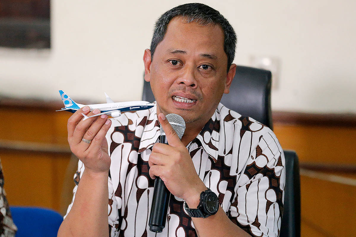 National Transportation Safety Committee investigator Nurcahyo Utomo holds a model of an airplane during a press conference in Jakarta, Indonesia, on Friday. (AP Photo/Tatan Syuflana)