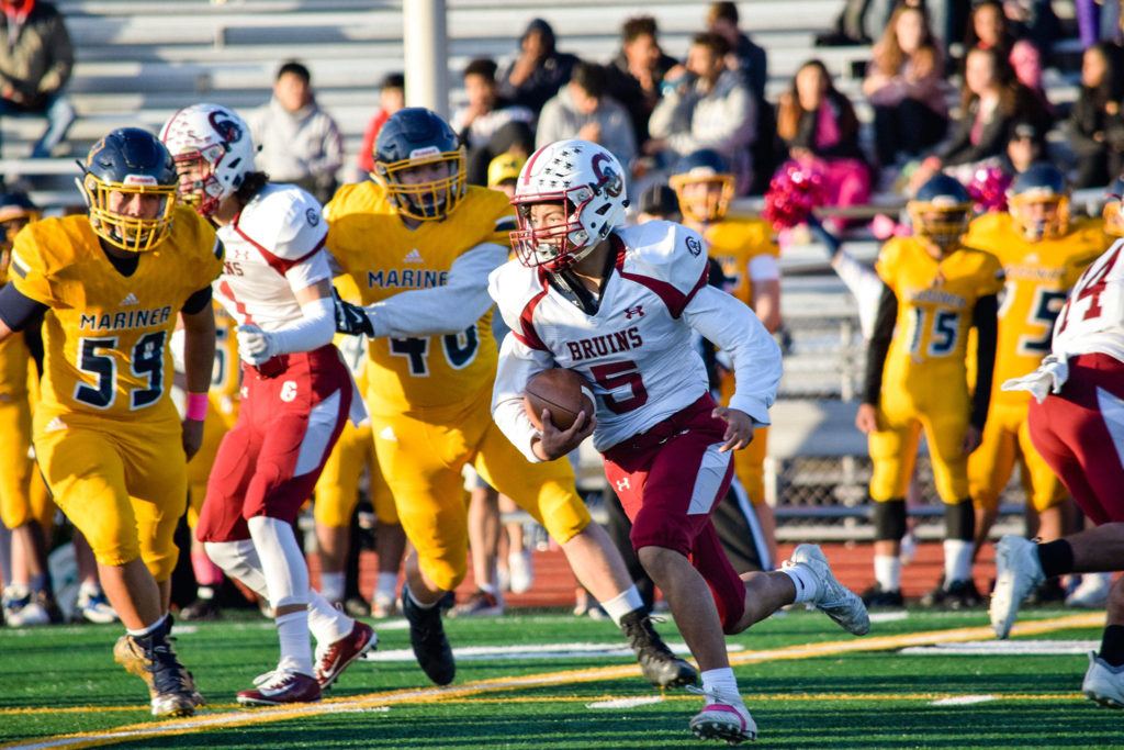 Sophomore running back Xander Larsen runs through the Mariner defense on Friday, Oct. 25 at Goddard Stadium in Everett. (Katie Webber / The Herald)

