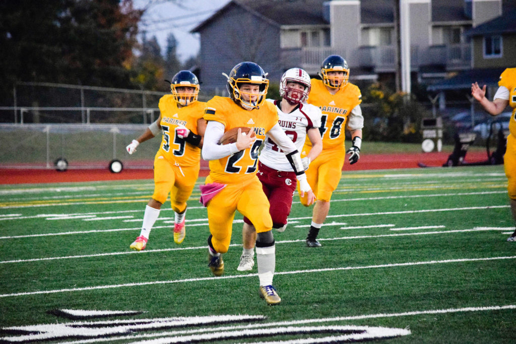 Junior quarterback Jackson Cole runs for a first down against Cascade on Friday, Oct. 25 at Goddard Stadium in Everett. (Katie Webber / The Herald)
