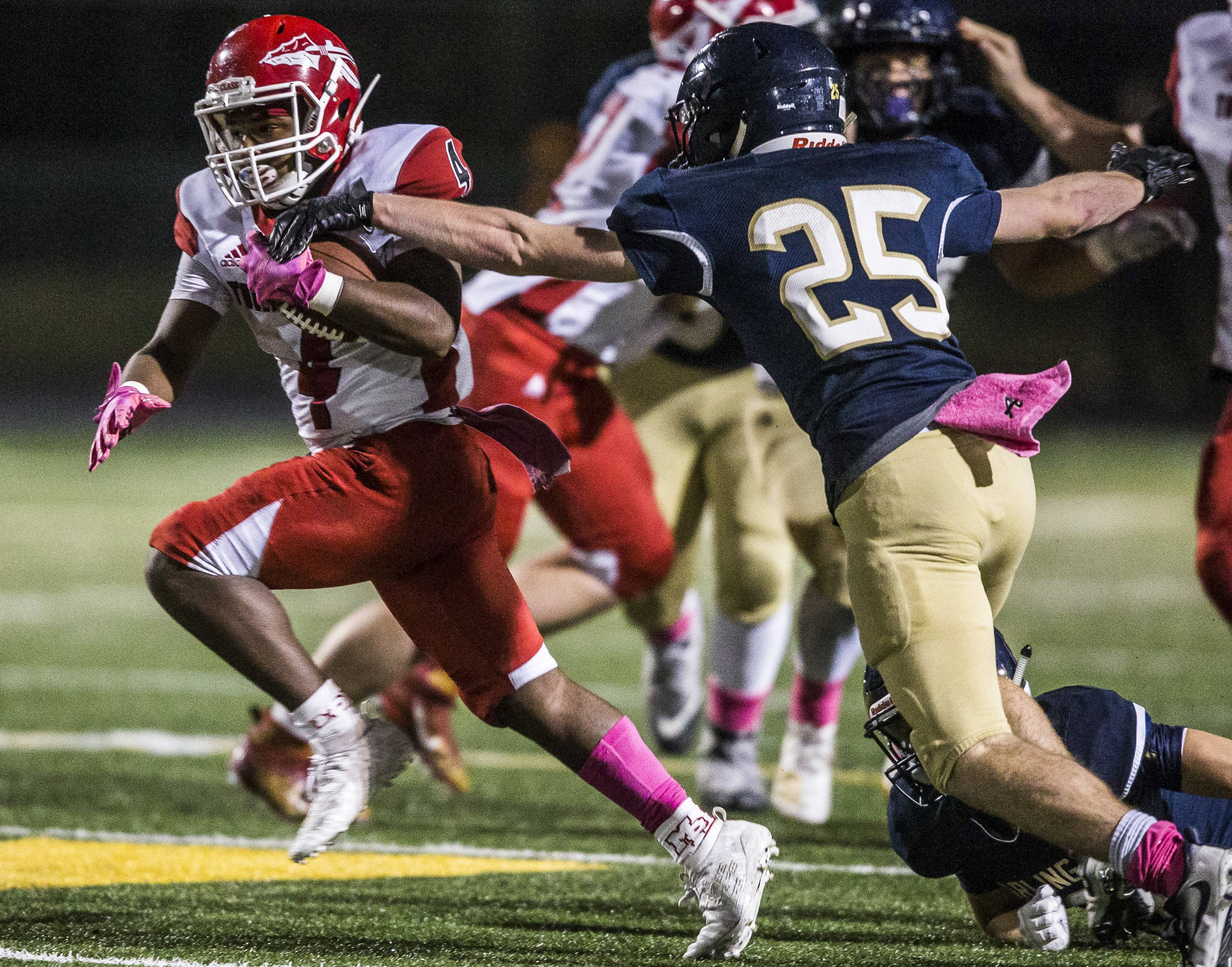 Marysville Pilchuck’s Jay Gray tries to evade Arlington’s Hunter Eastman during a Wesco 3A North game on Friday at John C. Larson Stadium in Arlington. Gray and the Tomahawks beat Eastman and the Eagles 42-14 to clinch the league title. (Olivia Vanni / The Herald)