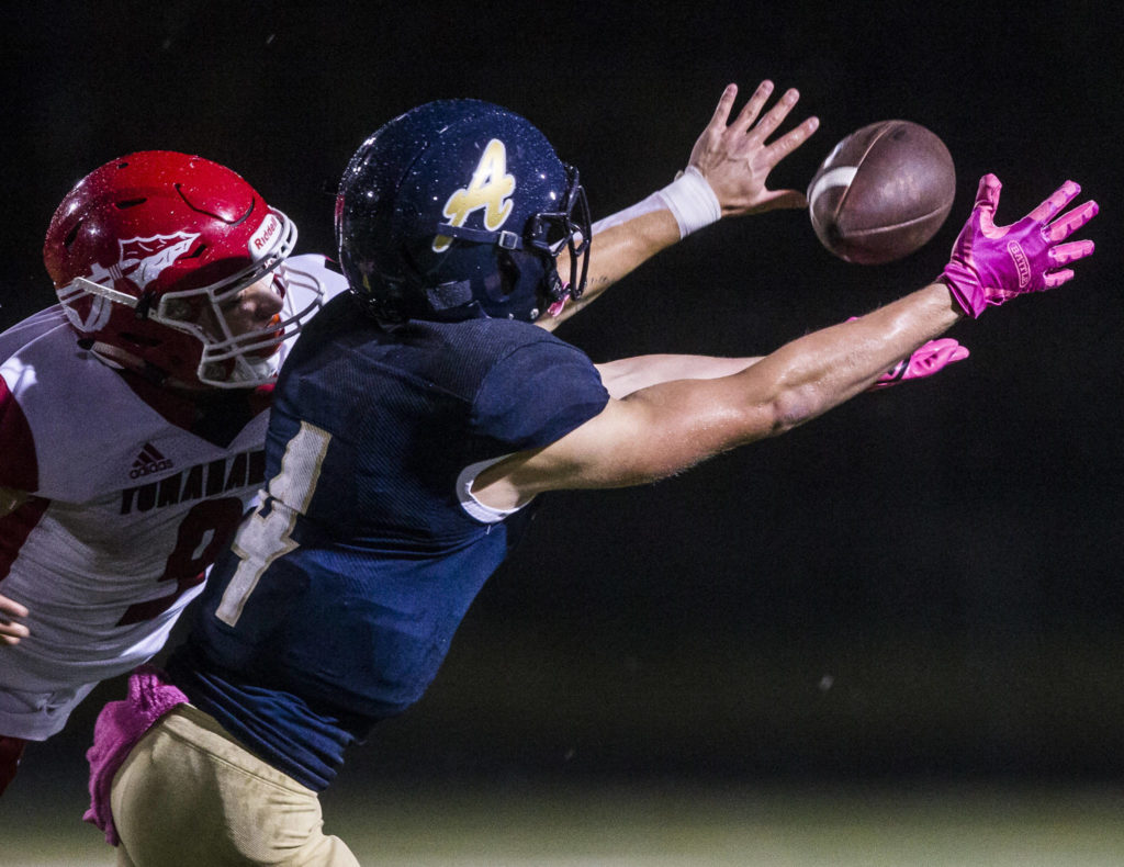 Marysville Pilchuck’s Jordan Justice (left) deflects a pass away from Arlington’s Joseph Schmidt during a Wesco 3A North game on Friday at John C. Larson Stadium in Arlington. Marysville Pilchuck beat Arlington 42-14 to win the Wesco 3A North title. (Olivia Vanni / The Herald)
