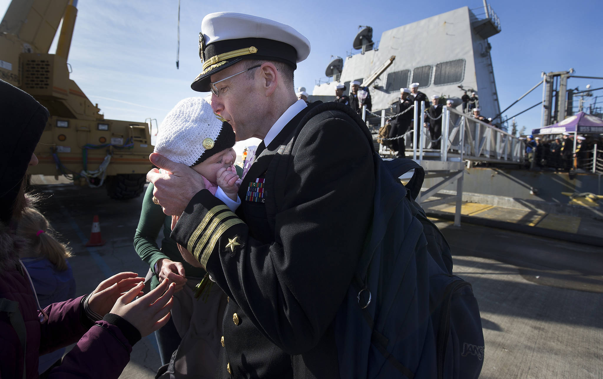 Cmdr. Robert Laird greets his three-month old daughter, Agnes, for the first time as the USS Momsen returns Monday to Naval Station Everett. (Andy Bronson / The Herald)                                Commander Robert Laird greets his three-month-old daughter Agnes for the first time as the USS Momsen (DDG-92) returns to Naval Station Everett after a deployment to the Pacific on Monday in Everett. (Andy Bronson / The Herald)