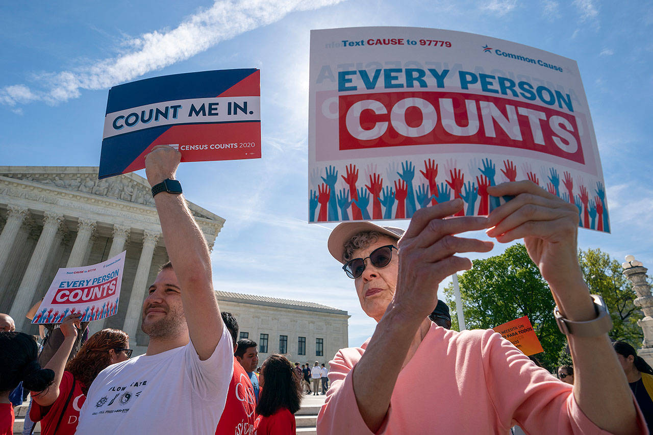 Immigration activists rally in April outside the Supreme Court as the justices hear arguments over the Trump administration’s plan to ask about citizenship on the 2020 Census. (AP Photo/J. Scott Applewhite, File)
