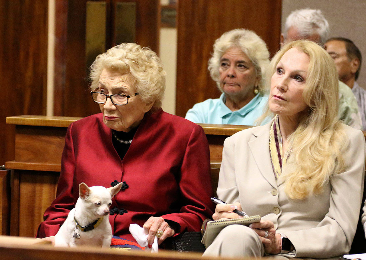 Native Hawaiian heiress Abigail Kawananakoa (left) sits next to her wife, Veronica Gail Worth, while the couple’s Chihuahua sits on her lap during a court hearing in Honolulu, on Friday. (AP Photo/Jennifer Sinco Kelleher)