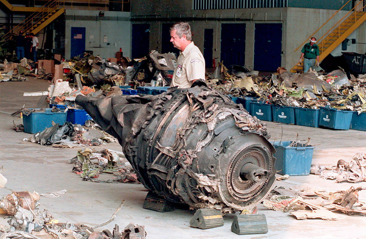 A mechanic walks past the remains of an engine from USAir Flight 427 in a hangar in 1994 in Coraopolis, Pennsylvania. (AP Photo/Gene J. Puskar)