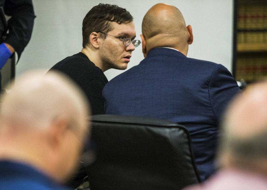 Anthony Garver talks with his attorney as the judge reads his remarks before the verdict at the Snohomish County Courthouse on Tuesday in Everett. (Olivia Vanni / The Herald)
