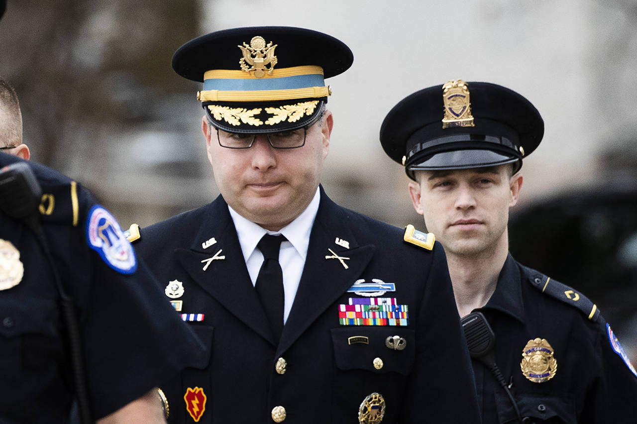 Army Lieutenant Colonel Alexander Vindman, a military officer at the National Security Council, center, arrives on Capitol Hill in Washington on Tuesday to appear before a House Committee on Foreign Affairs, Permanent Select Committee on Intelligence, and Committee on Oversight and Reform joint interview with the transcript to be part of the impeachment inquiry into President Donald Trump. (AP Photo/Manuel Balce Ceneta)
