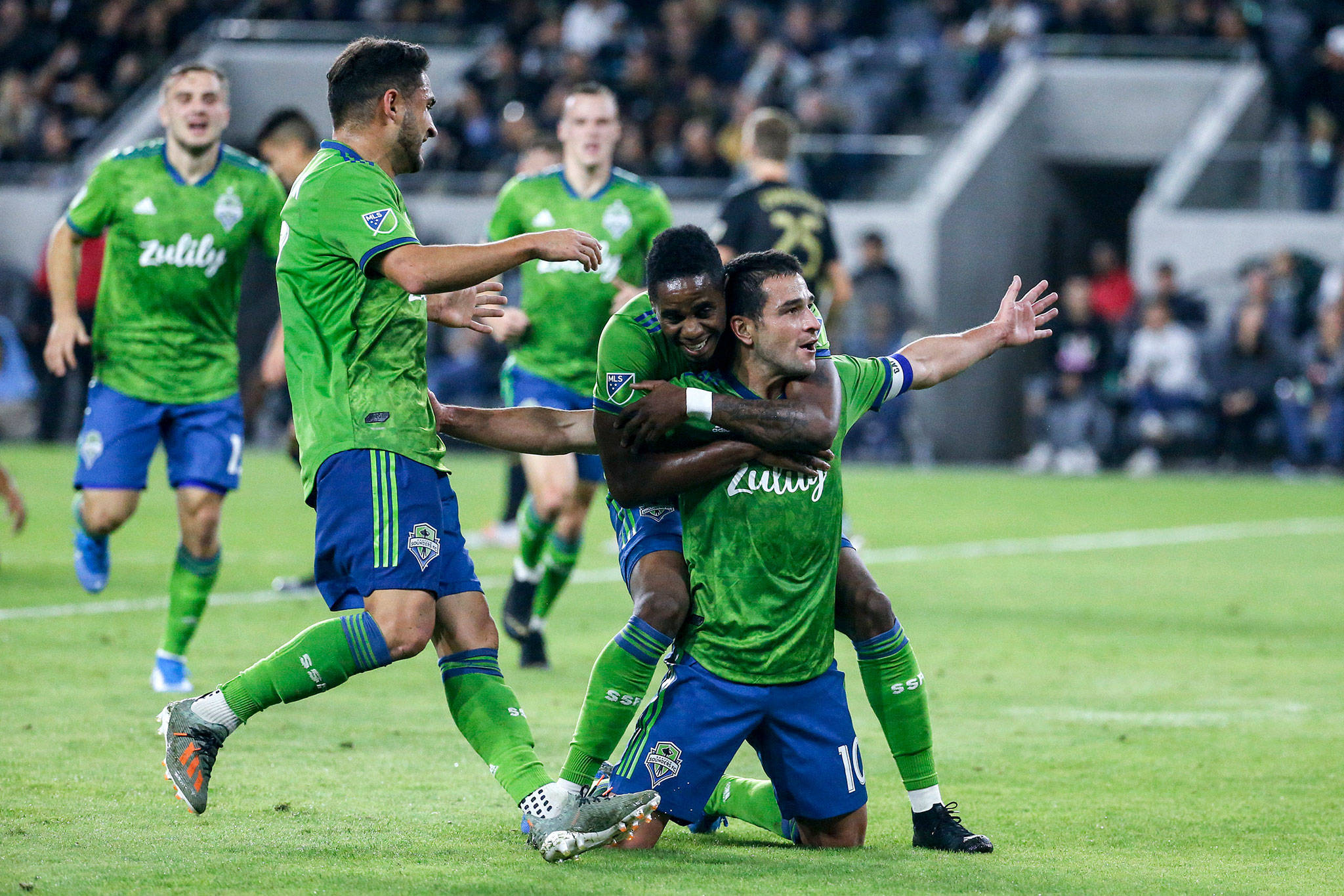 Sounders midfielder Nicolas Lodeiro (right) celebrates his goal with teammates during the first half of the MLS Western Conference final against Los Angeles FC on Tuesday in Los Angeles. (AP Photo/Ringo H.W. Chiu)