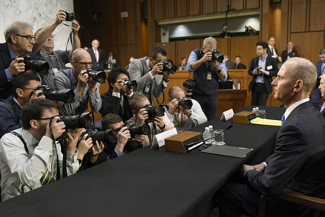 Boeing Company President and Chief Executive Officer Dennis Muilenburg (right) is surrounded by photographers on Capitol Hill in Washington on Tuesday, before the start of a Senate Committee on Commerce, Science, and Transportation hearing on “Aviation Safety and the Future of Boeing’s 737 MAX.” (AP Photo/Susan Walsh)