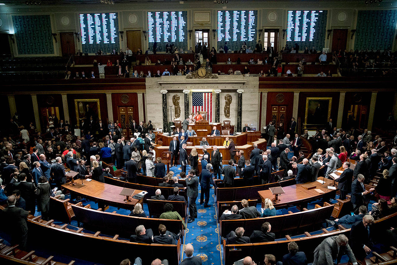 Vote Tallies are displayed as House members vote on a resolution on impeachment procedure to move forward into the next phase of the impeachment inquiry into President Trump, in the House Chamber on Capitol Hill in Washington on Thursday. (AP Photo/Andrew Harnik)