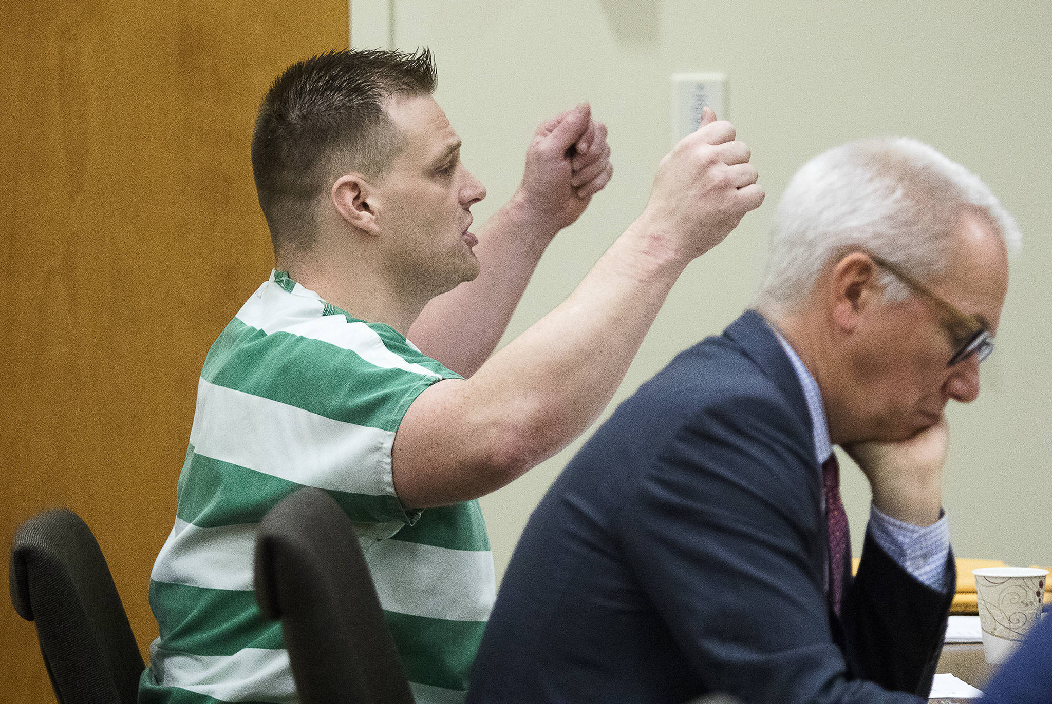 Wanting to delay his sentencing, Harry Nettleton IV, 39, speaks to the judge, while Defense attorney Donald Wackerman listens, before abruptly agreeing to go forward with his sentencing in Snohomish County Court on Monday, Nov. 25, 2019 in Everett, Wash. The Renton man must serve 12⅔ years in prison for commandering a taxi cab to flee gunfire, leading police on a chaotic chase from Lynnwood to Northgate. (Andy Bronson / The Herald)
