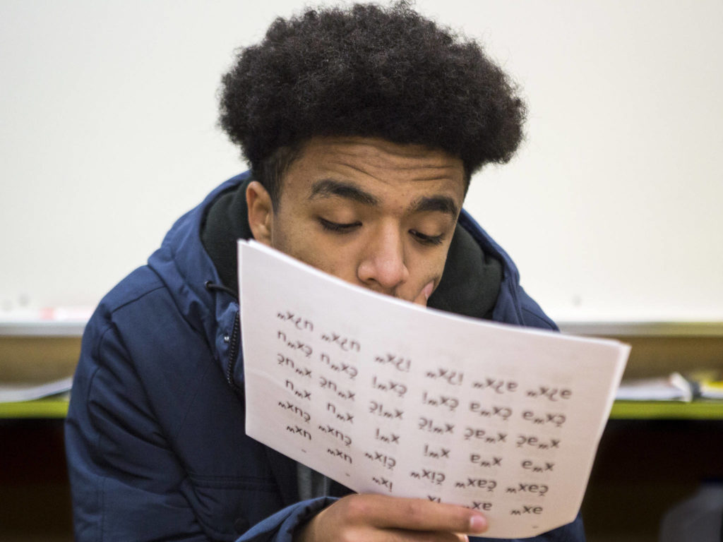 Elson Battle studies his Lushootseed worksheet during class. (Olivia Vanni / The Herald)
