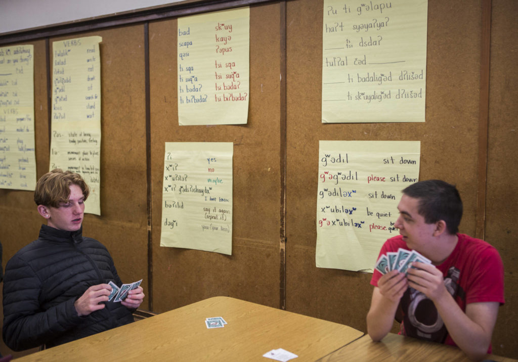 Anthony Sampson, left, and Cobain Lofthouse, right, play Go Fish with Lushootseed cards during class. (Olivia Vanni / The Herald)
