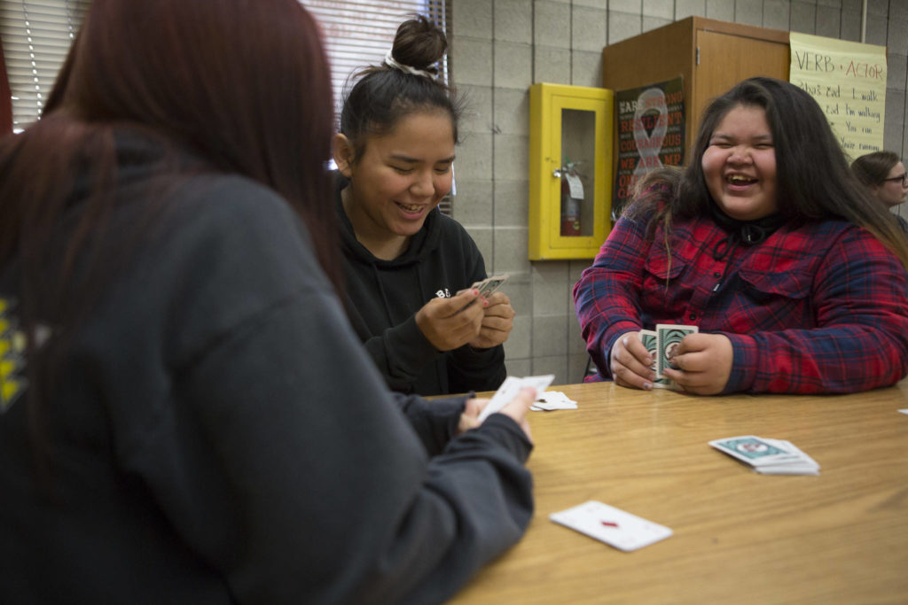 Hope Iukes, right, and Shaelee Jack, left, laugh while they play Go Fish during their Lushootseed class. (Olivia Vanni / The Herald)
