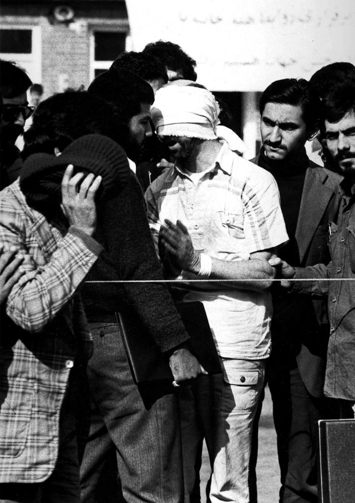 In this undated image, one of U.S. hostages, blindfolded and with his hands bound, is being displayed to the crowd outside the U.S. Embassy in Tehran by Iranian hostage takers. (AP Photo)
