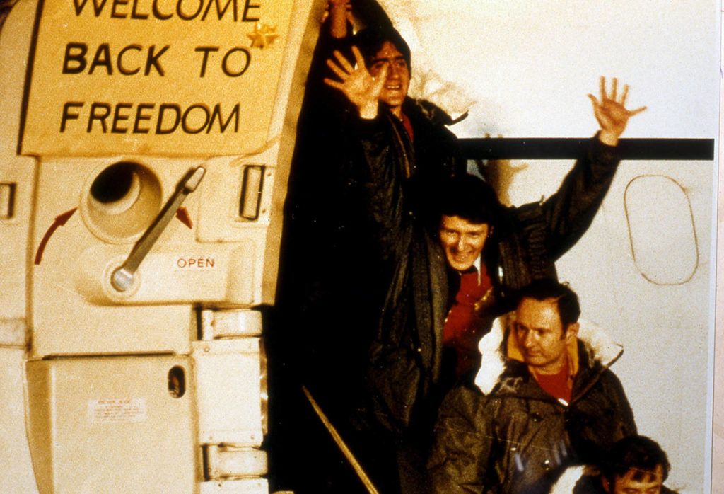 Four of the 52 American hostages freed from Iran leave a U.S. Air Force hospital plane after its arrival at Rhein-Main Air Base, near Frankfurt, Germany, on Jan. 21, 1981. The group was later met by former President Jimmy Carter, who had negotiated for their release right up to the last hours of his Presidency. (AP Photo/Str)
