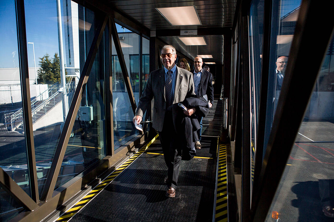 Paine Field is one of 11 smaller airports with scheduled passenger service. Here, people begin boarding the first flight during the airport’s grand opening on March 4 this year. (Olivia Vanni / Herald file)