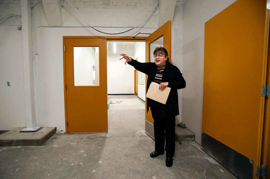 Earlier this year, Barbara George, executive director of the Everett Museum of History, points out a ramp that leads from the alley to the building’s lower level. Someday, Everett’s antique bookmobile may drive or be rolled into the museum to be on long-term display. (Dan Bates / The Herald)

