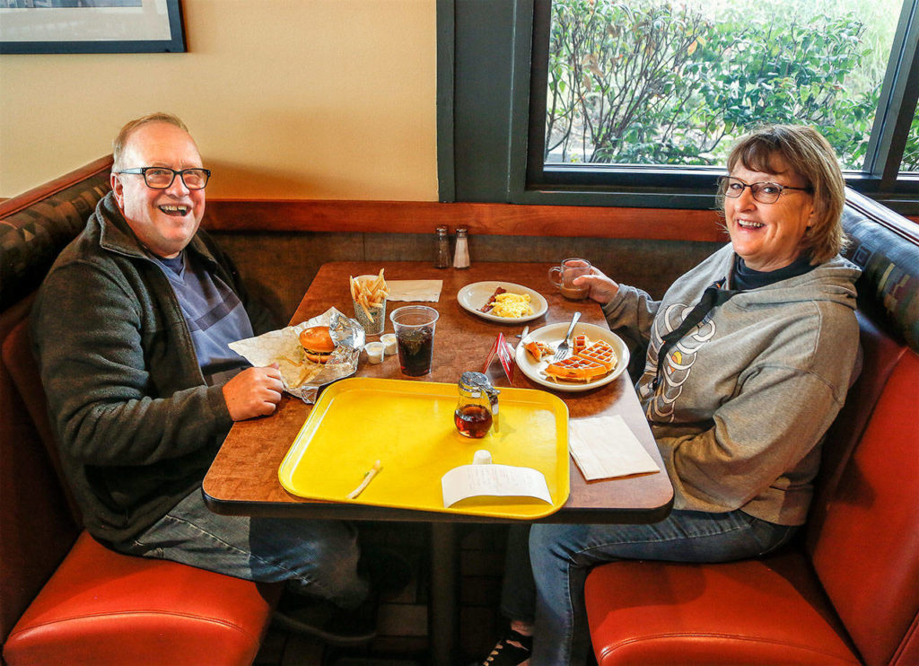 It’s easy to see why Tom and Carol Lee of Marysville have been regular customers the last 10 years at Everett’s Burgermaster. For breakfast, she likes scrambled eggs and waffles. He likes a hamburger, fries and a soda. The restaurant is closing Sunday. (Dan Bates / The Herald)

