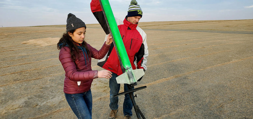 Instructor Will Hamp and club president Trixie Teng ready her rocket for launch. (Edmonds Community College)
