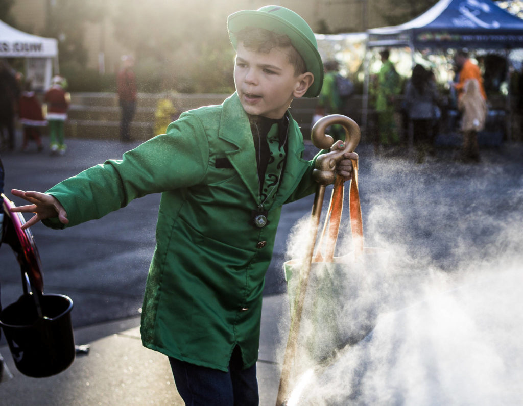 Paxton Jaross, 7, walks by the fountain in Wetmore Plaza during Downtown Trick-or-Treating on Oct. 31, 2019 in Everett, Wash. (Olivia Vanni / The Herald)
