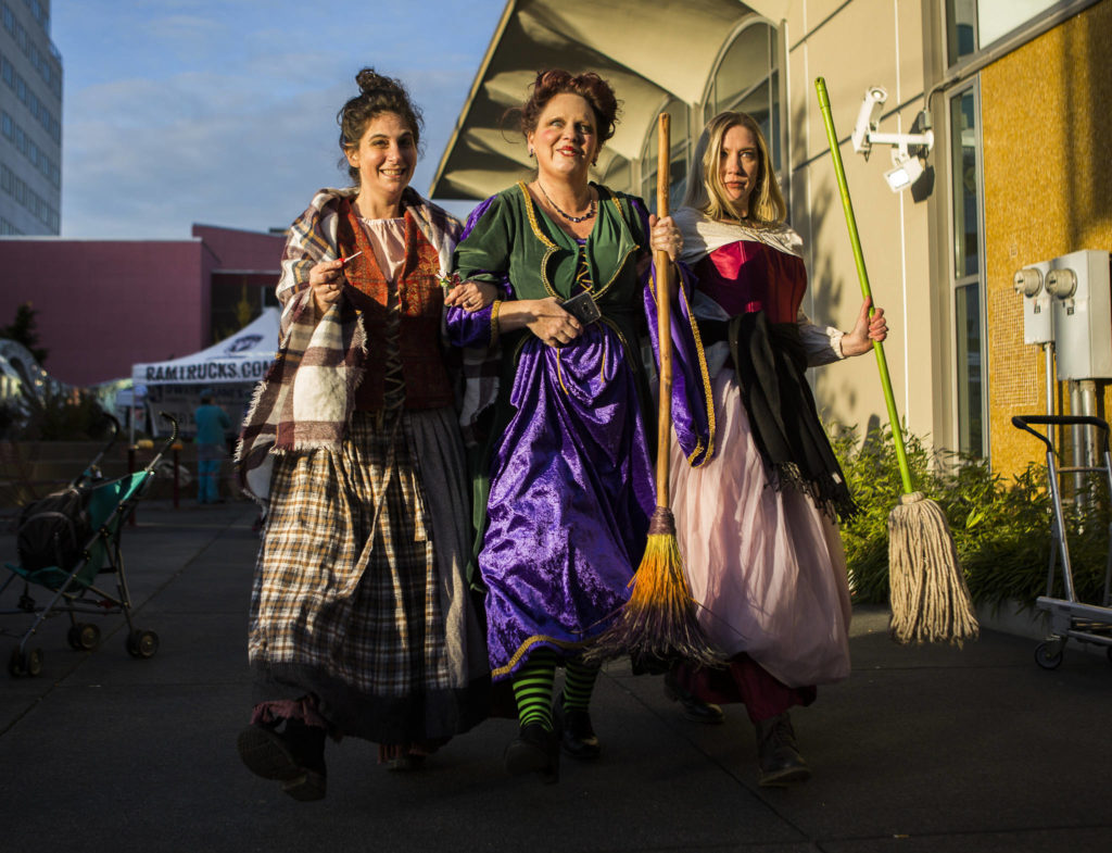 Erica Weis, Tammy Weiberger and Sara Coiley, dressed as the Sanderson sisters from “Hocus Pocus”, walk through Wetmore Plaza during downtown trick-or-treating Thursday in Everett. (Olivia Vanni / The Herald)
