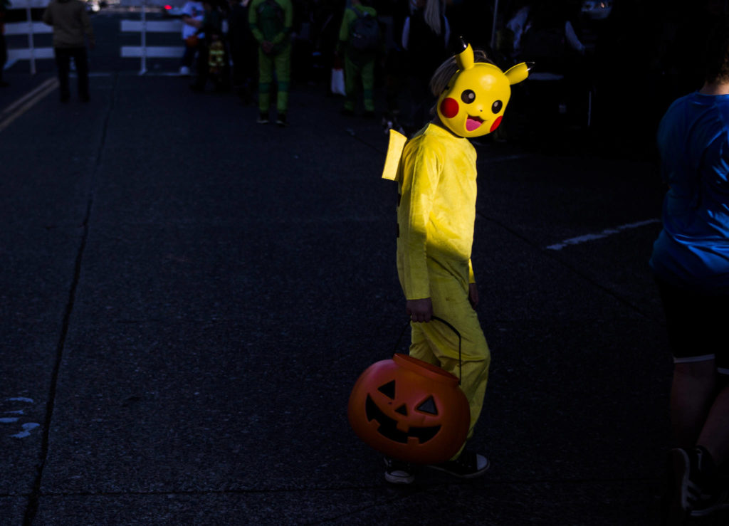 A Pikachu walks across California Street during downtown trick-or-treating Thursday in Everett. (Olivia Vanni / The Herald)
